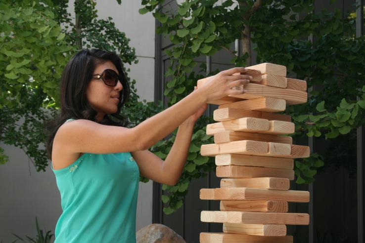A person playing Giant Jenga.